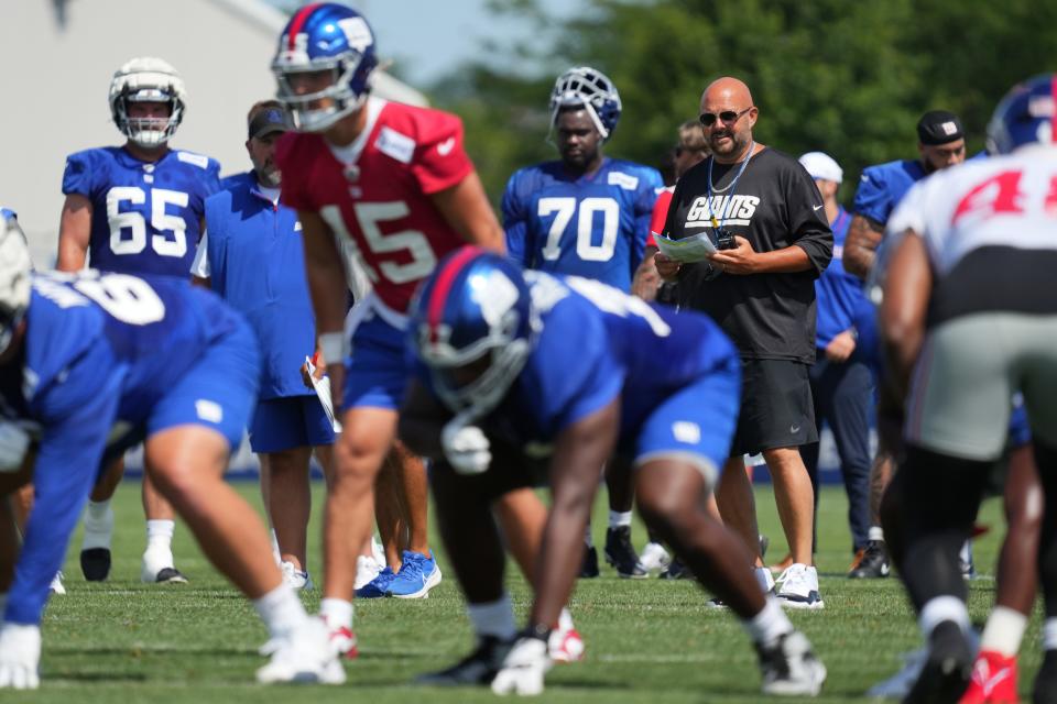 Jul 26, 2024; East Rutherford, NJ, USA; New York Giants head coach Brian Daboll watches as New York Giants quarterback Tommy DeVito (15) prepares to snap a ball during training camp at Quest Diagnostics Training Center. Mandatory Credit: Lucas Boland-USA TODAY Sports