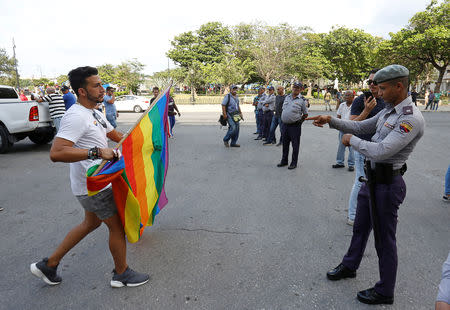 A Cuban LGBT activist argues with security personnel while participating in an annual demonstration against homophobia and transphobia in Havana, Cuba May 11, 2019. REUTERS/Stringer