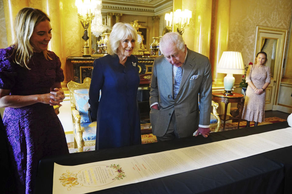 Britain's King Charles III and Queen Camilla are presented with the Coronation Roll, an official record of their Coronation, by the Clerk of the Crown in Chancery, Antonia Romeo, at Buckingham Palace, central London, Wednesday May 1, 2024. PA Photo. From the early seventeenth century, the rolls provide a record of the accession of the sovereign, followed by a proclamation of the coronation and of the peers' attendance, the appointment of the Court of Claims and the petitions to it (in full) with their answers, a short account of the ceremony with the services performed, and a list by rank of those doing homage. From 1702 the oath sworn by the sovereign is included as a schedule, and except in the case of George IV, this is signed. Declarations against the transubstantiation of the sacrament and the archbishop of Canterbury's certificate are included from 1714 onwards. See PA story ROYAL CoronationRoll. Photo credit should read: Victoria Jones/PA Wire /PA via AP)