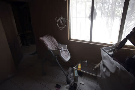 An abandoned baby chair is seen inside a house seized by authorities in Ciudad Juarez May 23, 2014. REUTERS/Jose Luis Gonzalez