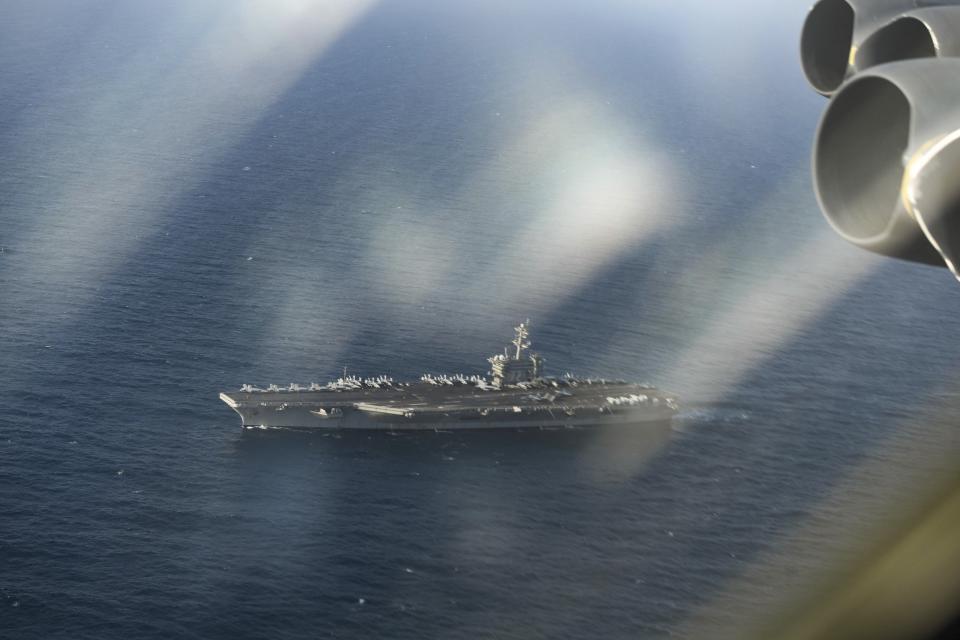 In this Saturday, June 1, 2019 photo, a U.S. Air Force B-52H Stratofortress assigned to the 20th Expeditionary Bomb Squadron, and the U.S. Navy carrier USS Abraham Lincoln, conduct joint exercises in the U.S. Central Command area of responsibility in Arabian sea. (Staff Sgt. Erin Piazza/U.S. Air Force via AP)