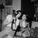 <p>In her fashionable townhouse in London's Mayfair, Joan Collins and her husband, Maxwell Reed, admire their pet monkey, Spider. </p>