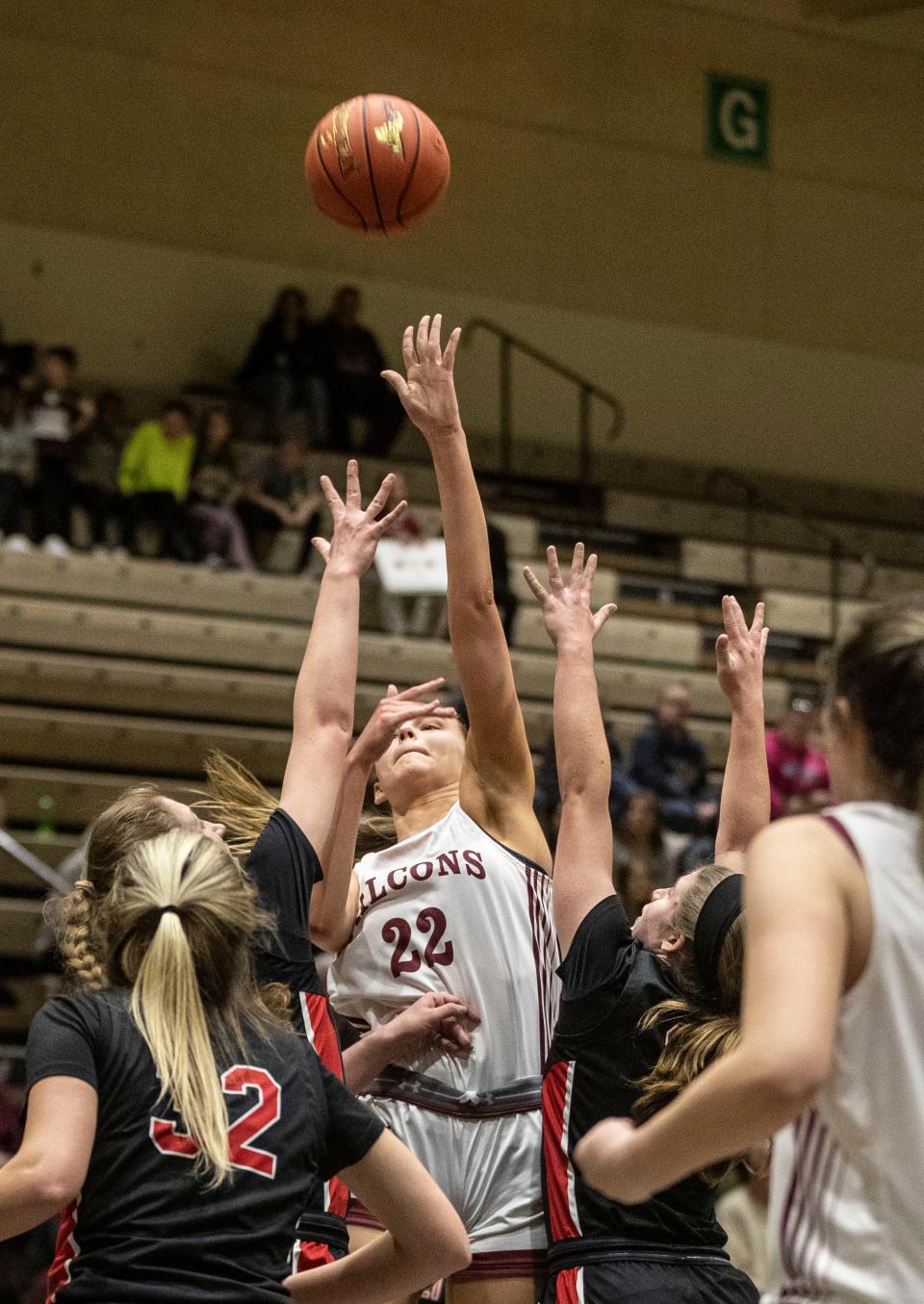 Albertus Magnus' Julia Scott goes up for a shot over Hilton defenders in the state Class AA girls basketball final on March 16, 2024.