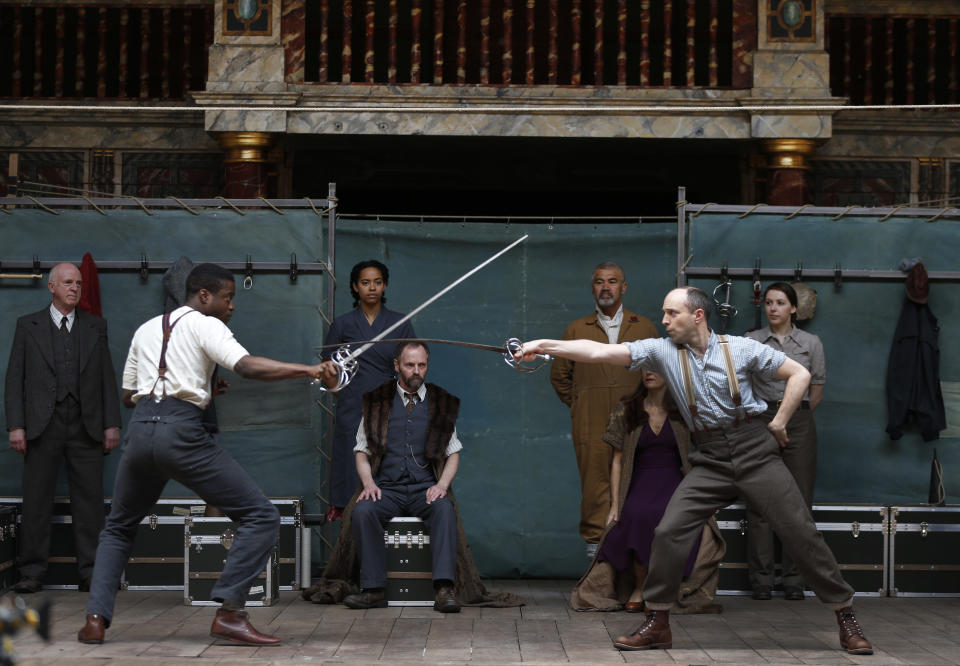 Actors perform a scene from William Shakespeare's Hamlet for members of the media during a photo call to present Hamlet at Shakespeare’s Globe theatre, London, Wednesday, April 23, 2014. Four centuries after his death, William Shakespeare is probably Britain's best-known export, his words and characters famous around the world. Shakespeare's Globe theater is setting out to test the Bard's maxim that "all the world's a stage" by taking "Hamlet" to every country on Earth world, more than 200 in all. (AP Photo/Lefteris Pitarakis)