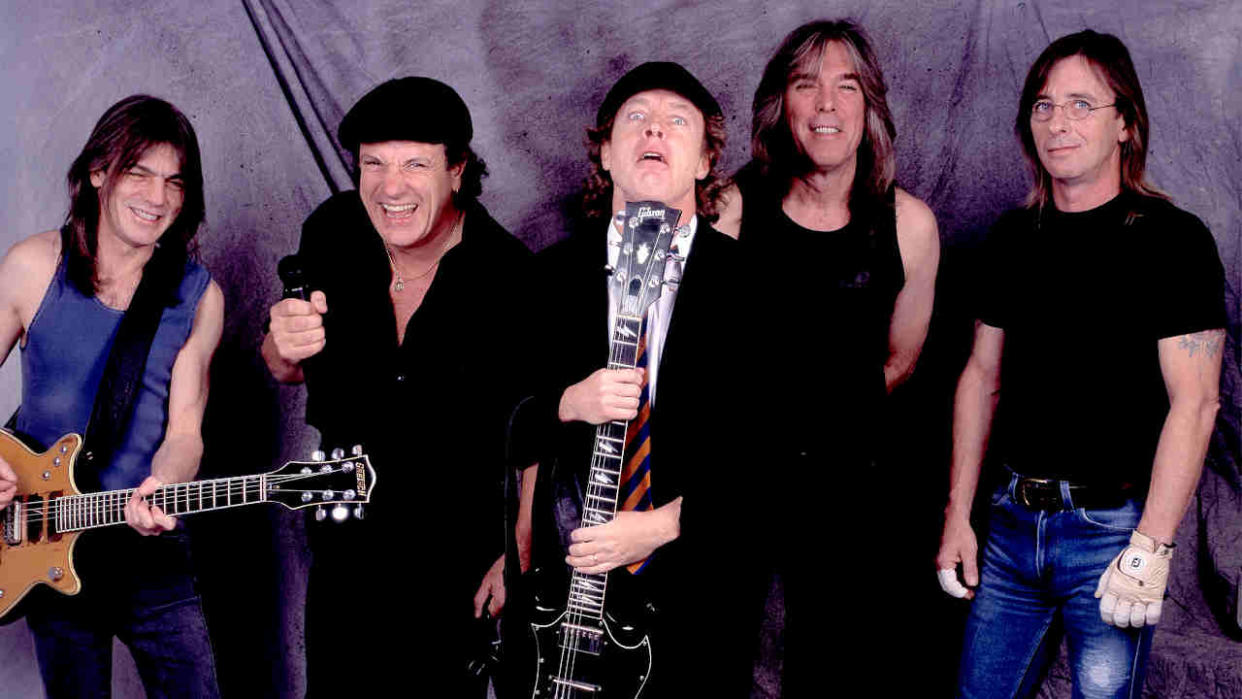  AC/DC standing in front of a grey backdrop 