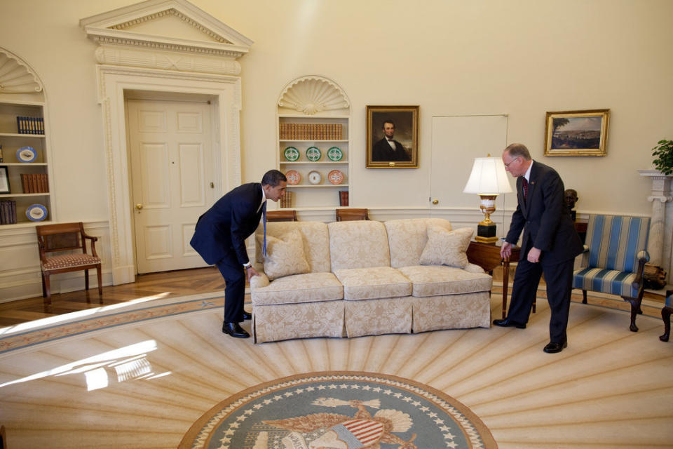 Obama and Vermont Gov. Jim Douglas move a couch in the Oval Office on Feb. 2, 2009. Douglas met with the president about the economic recovery plan.