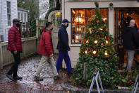 President Joe Biden, center, walks by shops in Nantucket, Mass., Friday, Nov. 26, 2021. (AP Photo/Carolyn Kaster)