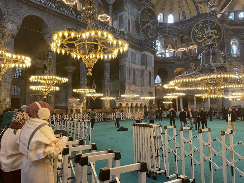 Women stand behind a barrier in the area of the Hagia Sophia reserved for female tourists. Linda Say/dpa