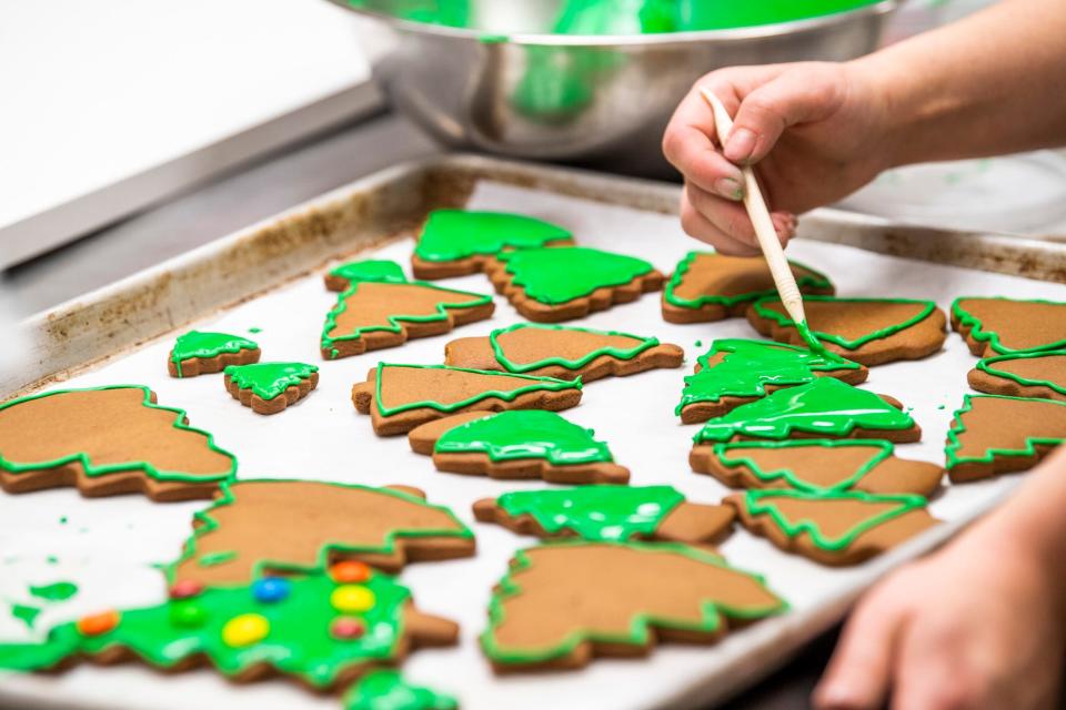 Kat Hall makes trees for an Indiana University-themed gingerbread scene last year.