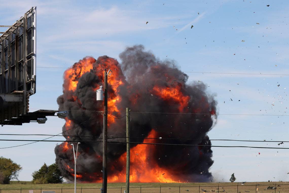 In this photo provided by Nathaniel Ross Photography, a historic military plane crashes after colliding with another plane during an airshow at Dallas Executive Airport in Dallas on Saturday, Nov. 12, 2022. (Nathaniel Ross Photography via AP)