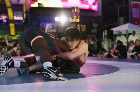 U.S. wrestler James Green (L) spars with Japanese wrestler Nobuyoshi Takojima at the "Beat The Streets" wrestling event in Times Square, New York City, U.S., May 17, 2017. REUTERS/Joe Penney