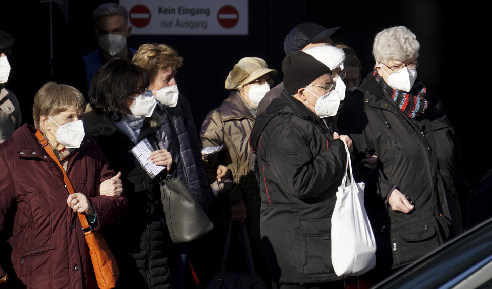 People queue in front of the new coronavirus, COVID-19, vaccination center at the 'Arena Treptow' in Berlin, Germany, Monday, Feb. 1, 2021. Chancellor Angela Merkel and German state governors are going to talk on Monday with representatives of the pharmaceutical industry beefing up the country's sluggish vaccination campaign. (AP Photo/Michael Sohn)