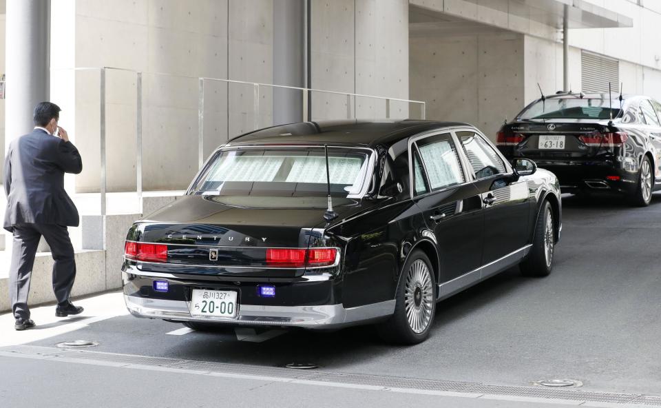 A car, left, carrying Japanese Prime Minister Shinzo Abe, arrives at Keio University Hospital in Tokyo, Monday, Aug. 17, 2020. Prime Minister Abe went to a hospital Monday for what Japanese media reported was a regular checkup, although the visit regenerated ongoing worries about his health.(Kyodo News via AP)