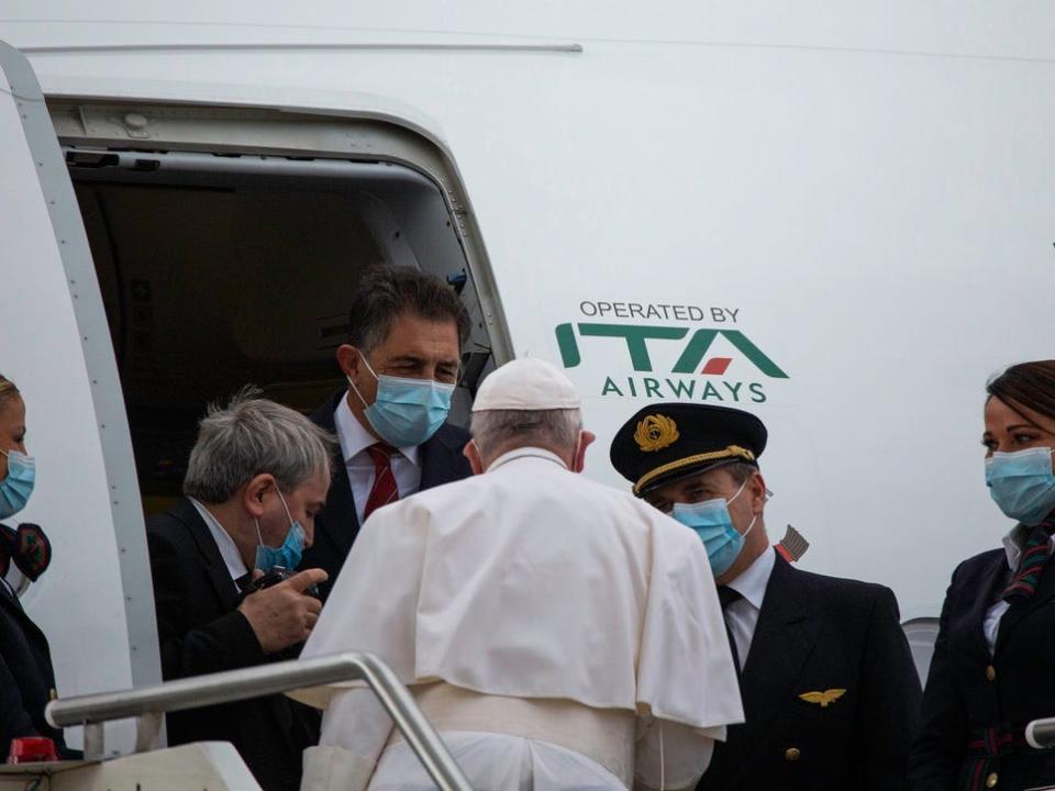 Pope Francis boards an ITA plane.