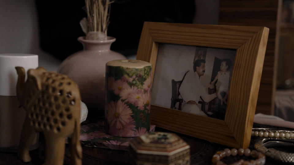 A framed photo of Reyhaneh Jabbari as a child, with her father.