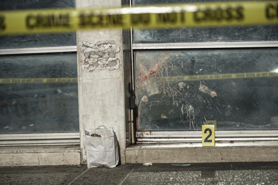 New York Police Department mark the scene of an attack in Manhattan's Chinatown neighborhood, Saturday, Oct. 5, 2019 in New York.  Four men who are believed to be homeless were brutally attacked and killed early Saturday in a street rampage. NYPD Detective Annette Shelton said that a fifth man remained in critical condition after also being struck with a long metal object that authorities recovered. (AP Photo/Jeenah Moon)