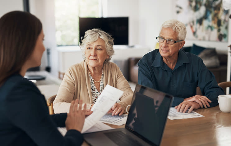 A financial advisor working with a senior couple to create an estate plan.