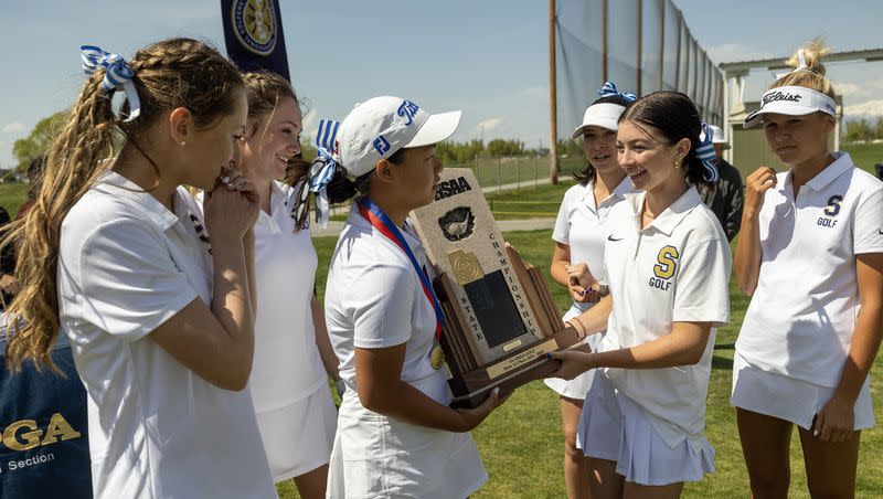 Skyline golfers admire their trophy after taking the 5A high school state championship at Remuda Golf Course in Ogden on Tuesday, May 9, 2023.
