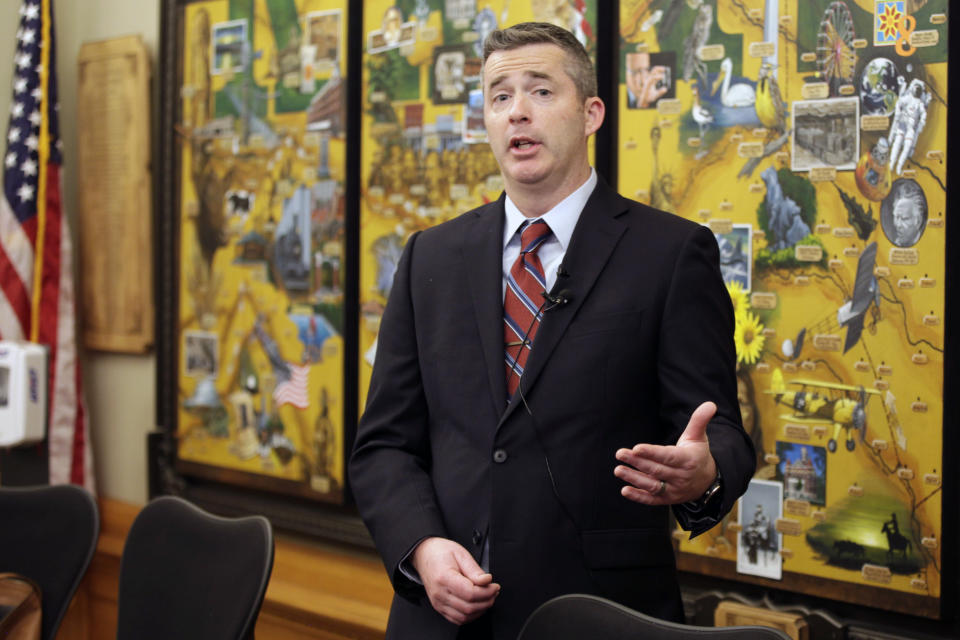 Adam Proffitt, budget director for Kansas Gov. Laura Kelly, explains her spending proposals for reporters during a briefing, Thursday, Jan. 12, 2023, at the Statehouse in Topeka, Kansas. Kelly is headed toward big fights with the Republican-controlled Legislature over spending on special education, pay raises for government workers and how much the state should sock away for worse economic times. (AP Photo/John Hanna)