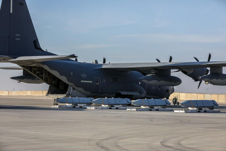 Joint Air to Surface Standoff Missile (JASSM) cradles near a transport aircraft