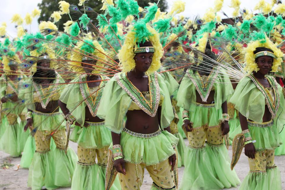 Performers dance through the streets during Lagos Carnival in Lagos, Nigeria, Monday, April 1, 2013. Performers filled the streets of Lagos' islands Monday as part of the Lagos Carnival, a major festival in Nigeria's largest city during Easter weekend. (AP Photo/Sunday Alamba)