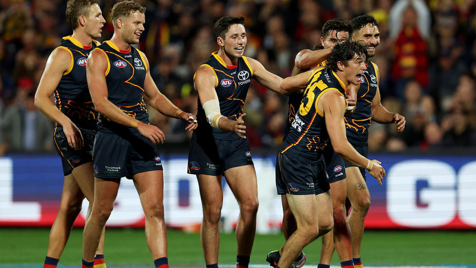 The Adelaide Crows celebrate a goal against Carlton.