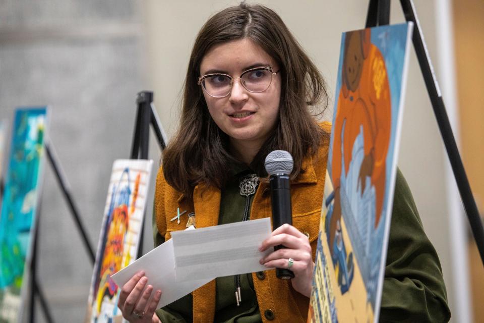 Jordan Crouch, of the College for Creative Studies editorial illustration class, talks about her design for the coming year's Chevrolet Detroit Grand Prix promotional poster at the Taubman Center for Design Education in Detroit on Wednesday, April 17, 2024. She won second place.