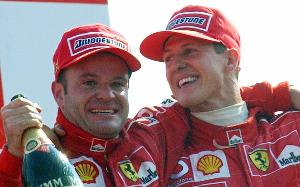 Ferrari driver Rubens Barrichello of Brazil, left, winner of the Grand Prix of Italy, celebrates on the podium with second placed Michael Schumacher of Germany, at Monza racetrack, Italy , Sunday, Sept.15, 2002 - AP/LUCA BRUNO 