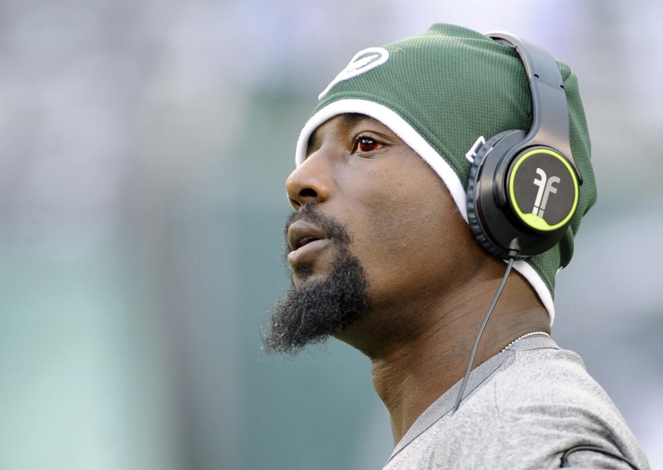 FILE - In this Dec. 22, 2013 file photo, New York Jets wide receiver Santonio Holmes looks on before an NFL football game against the Clevelnad Browns, in East Rutherford, N.J. The Jets have parted ways with Holmes, cutting the talented but injury-plagued playmaker after four seasons. The move Monday, March 10, 2014, which had been expected, saves the Jets $8.25 million, which Holmes was due to make as his base salary this season. (AP Photo/Bill Kostroun, File)