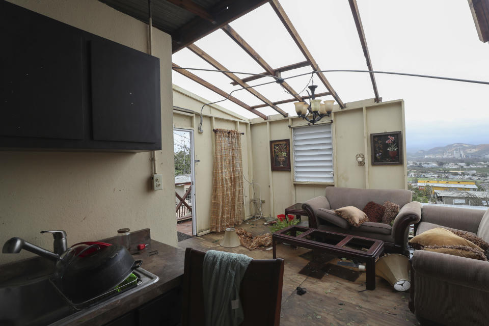 FILE - In this Sept. 21, 2017 photo, the home of Ashley Toledo's mother lays in ruins after the passing of Hurricane Maria in the Punta Diamante area of Ponce, Puerto Rico. Researchers said on April 22, 2021, they are launching a survey of the causes of deaths following the Category 4 storm to clear up questions about a death toll that analysts so far have attributed to factors such as power outages, building failures, and damaged roads. (AP Photo/Jorge A Ramirez Portela, File)