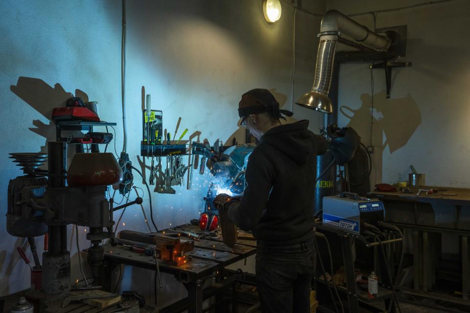 Welding engineer Artem Pastushyna, 27, welds parts for a vehicle that will be sent to soldiers on the frontlines, at a welding workshop in Lviv, western Ukraine, Sunday, March 27, 2022. “Any vehicles are very much in demand on the front line” by commanders, says Pastushyna. (AP Photo/Nariman El-Mofty)