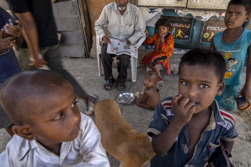 Children from a shanty area play on a footpath in Mumbai, India, Tuesday, May 2, 2023. Families in the countries poorest neighborhoods, especially illegal slums, often tap into the municipal water supply without permission as a means of survival. The World Bank says India is one of the most water-strapped countries in the world, due to population growth and worsening droughts and heatwaves. (AP Photo/Dar Yasin)