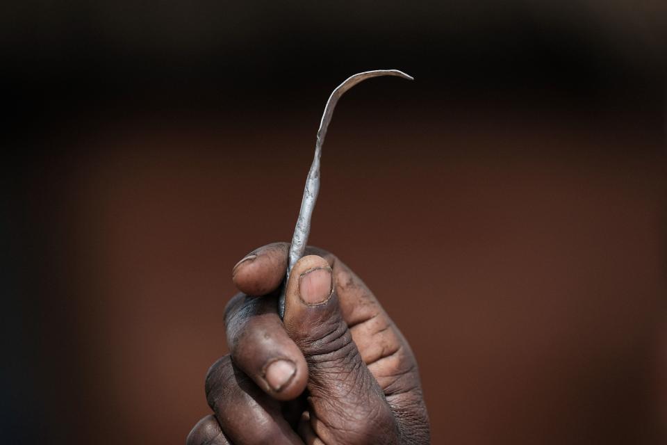 Ex-female genital mutilation (FGM) cutter Monika Cheptilak, who stopped practicing after the country set anti-FGM law in 2010, shows a homemade tool from a nail used for FGM, during the meeting of anti-FGM women group in Alakas village, bordering with Kenya, northeast Uganda on January 31, 2018. The UN estimates that over 200 million girls and women have experienced FGM which is a life-threatening procedure that involves the partial or total removal of a woman's external genitalia. February 6, 2018, marks the 6th International Day of Zero Tolerance for FGM. / AFP PHOTO / Yasuyoshi CHIBA        (Photo credit should read YASUYOSHI CHIBA/AFP via Getty Images)