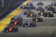 Ferrari driver Charles Leclerc of Monaco leads the field at the start of the Singapore Formula One Grand Prix, at the Marina Bay City Circuit in Singapore, Sunday, Sept. 22, 2019. (AP Photo/Lim Yong Teck)