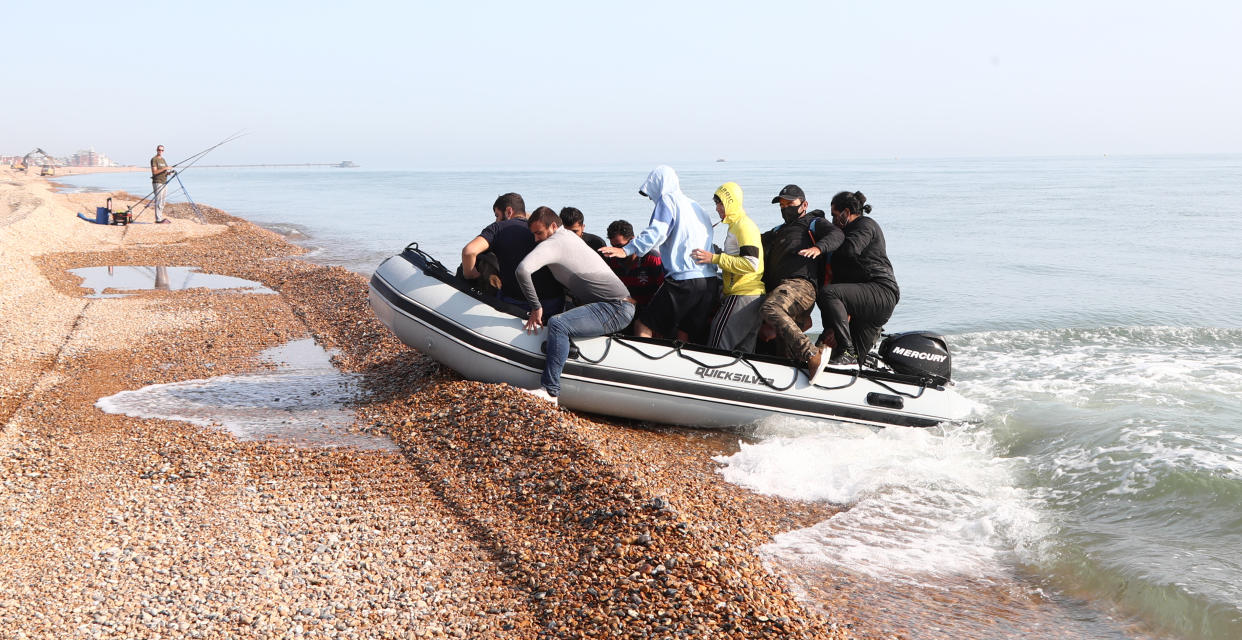 A group of people thought to be migrants arrive in an inflatable boat at Kingsdown beach, near Dover, Kent, after crossing the English Channel.
