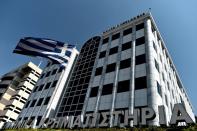 A Greek flag waves outside the Athens Stock Exchange on August 3, 2015