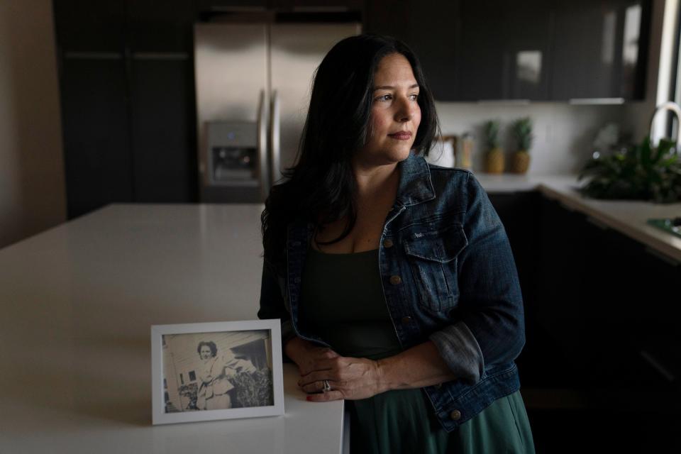 Stacy Cordova, whose aunt was a victim of California's forced sterilization program that began in 1909, stands for a photo next to a framed photo of her aunt, Mary Franco, Monday, July 5, 2021, in Azusa. Franco was sterilized when she was 13 in 1934. Franco has since died, but Cordova has been advocating for reparations on her behalf.