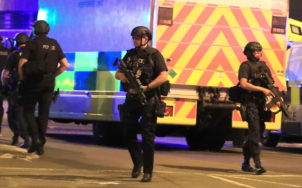 <p>Armed police close to the Manchester Arena after the terror attack at the Ariana Grande concert on 22 May 2017</p> (PA)