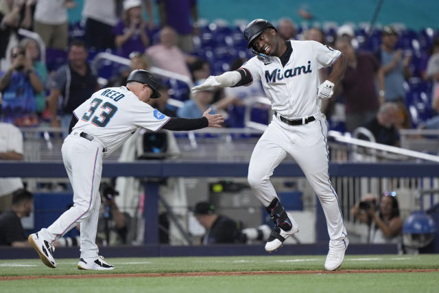 Miami Marlins' Jesus Sanchez, left, is congratulated by first base