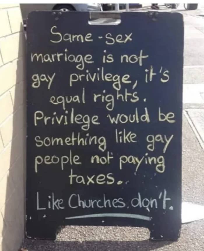 A chalkboard sign reads: "Same-sex marriage is not gay privilege, it's equal rights. Privilege would be something like gay people not paying taxes. Like churches don't."