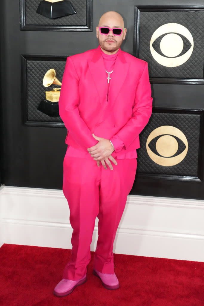 Fat Joe in hot-pink suit with diamond cross.