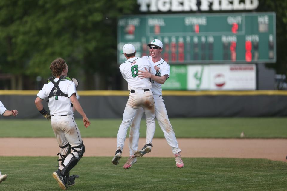 New Castle seniors Corbin Malott (No. 6) and Aydan Decker-Petty (right) celebrate after wining the sectional championship against Guerin Catholic at Yorktown High School on Monday, May 30, 2022.