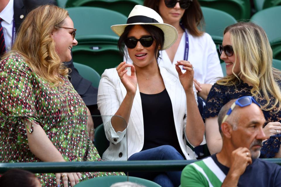 Britain's Meghan (C), Duchess of Sussex watches US player Serena Williams playing against Slovakia's Kaja Juvan during their women's singles second round match on the fourth day of the 2019 Wimbledon Championships at The All England Lawn Tennis Club in Wimbledon, southwest London, on July 4, 2019. (Photo by GLYN KIRK / AFP) / RESTRICTED TO EDITORIAL USE        (Photo credit should read GLYN KIRK/AFP/Getty Images)