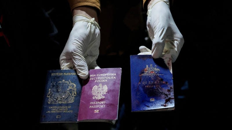 A man displays blood-stained British, Polish, and Australian passports after an Israeli airstrike, in Deir al-Balah, Gaza Strip, Monday, April 1, 2024. - Photo: Abdel Kareem Hana (AP)