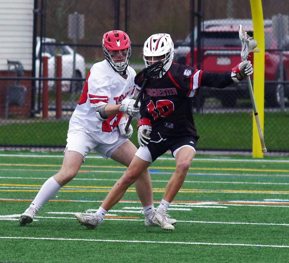 Bridgewater-Raynham's Colin Carfagna tries to get the ball away from Old Rochester's Andrew Nee in the first half of the lacrosse game earlier this month.