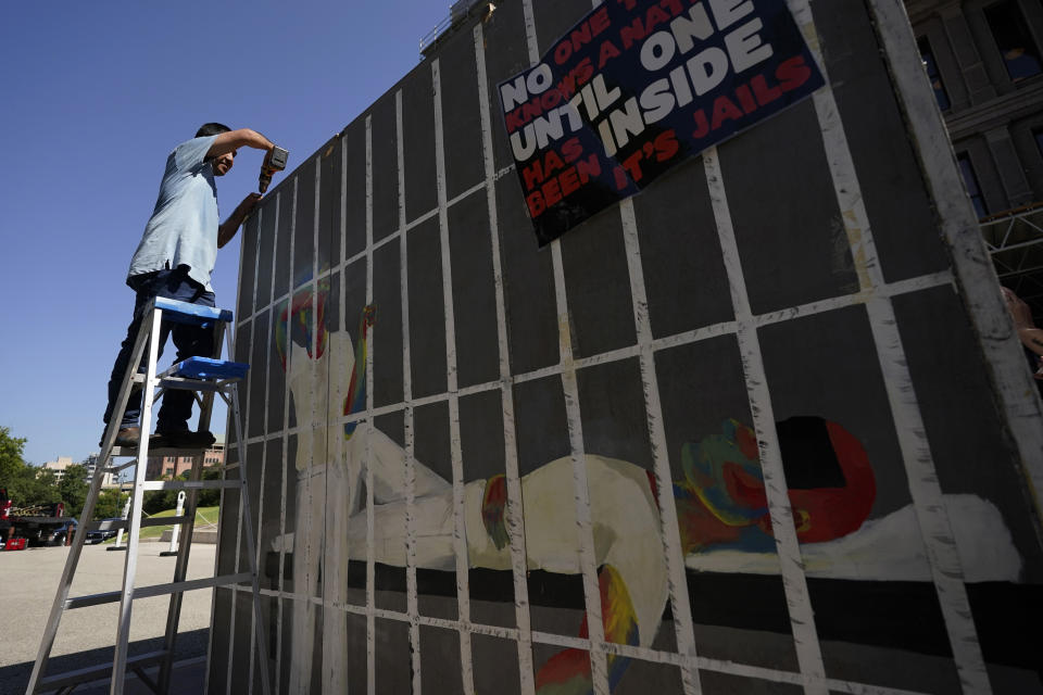 Advocates for cooling Texas prisons construct a make-shift cell before a rally on the steps of the Texas Capitol, Tuesday, July 18, 2023, in Austin, Texas. The group is calling for an emergency special session to address the deadly heat effecting inmates. (AP Photo/Eric Gay)