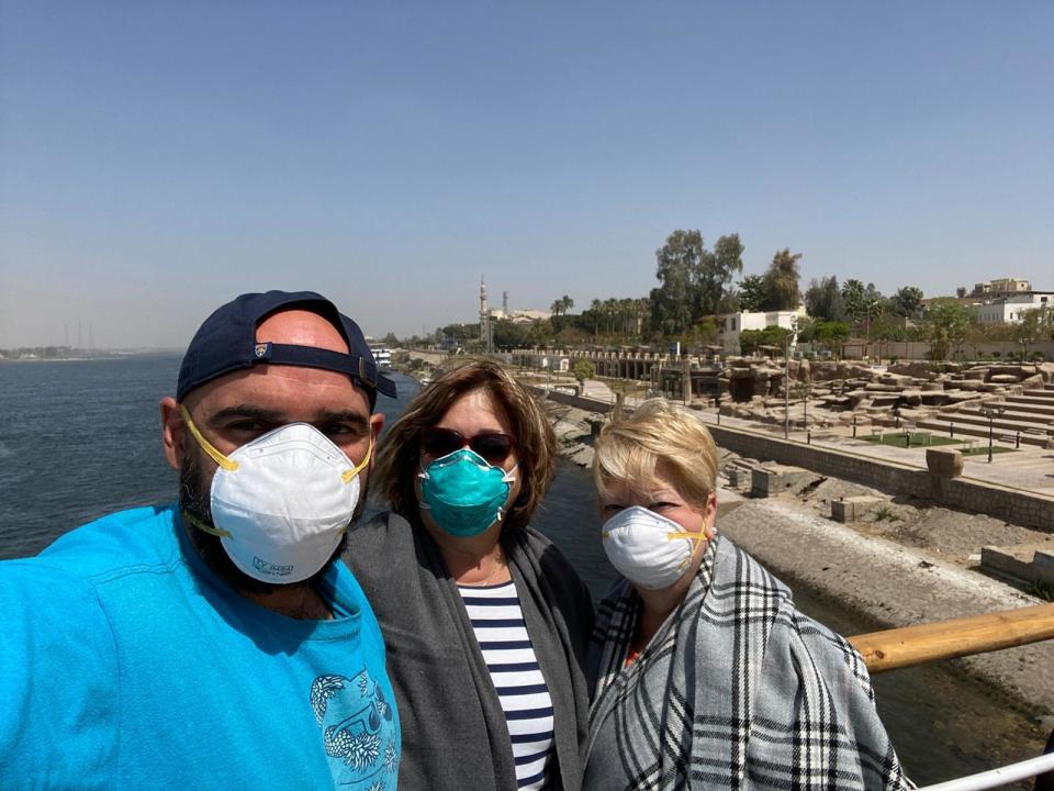 This photo provided by Javier Parodi, shows a selfie of Javier Parodi, left, Grissel Parodi and Amy Khamissian, on board the Nile cruise ship MS Asarade, in Luxor, Egypt, Tuesday, March 10, 2020. When Javier Parodi returned from a tour of Egypt’s famed ancient tombs in the southern city of Luxor last week, he was unnerved to see that his cruise ship wasn’t where he left it. The hulking MS Asara, carrying some 150 tourists, had docked, far from the rest, on the opposite bank of the Nile. Parodi, 35, found himself confined for days on the boat. The vast majority of people recover from the new virus. (Javier Parodi via AP)