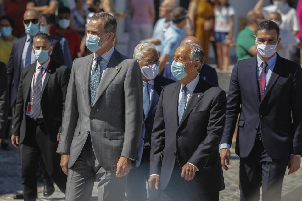 Spain's King Felipe VI, Portugal's President Marcelo Rebelo de Sousa, foreground, Portugal's Prime Minister Antonio Costa and Spain's Prime Minister Pedro Sanchez, background, walk during a ceremony to mark the reopening of the Portugal/Spain border in Elvas, Portugal, Wednesday, July 1, 2020. The border was closed for three and a half months due to the coronavirus pandemic. (AP Photo/Armando Franca)