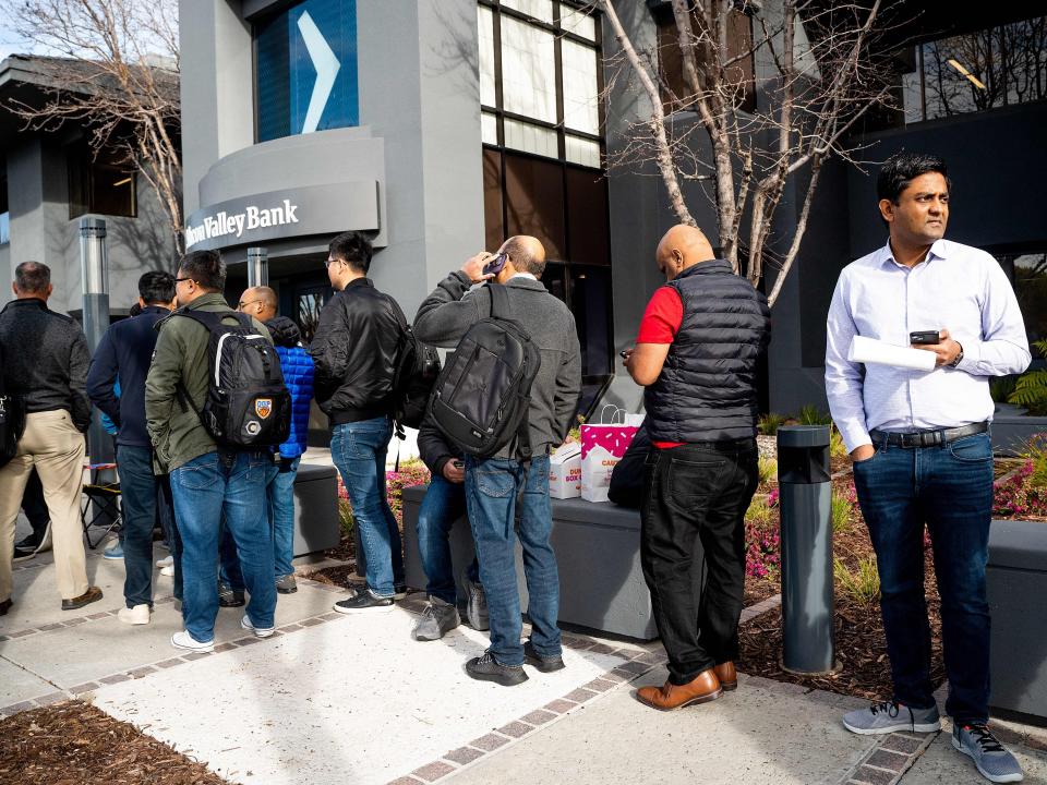 Silicon Valley Bank customers wait in line at SVBs headquarters in Santa Clara, California on March 13, 2023.