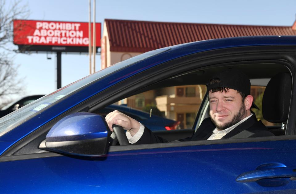 Anti-abortion activist Mark Lee Dickson sits in his car in front of the “prohibit abortion trafficking” billboard, Tuesday, Jan. 16, 2024, in Amarillo, Texas. (Via OlyDrop)